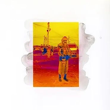 Thermal image showing a person and surroundings with heat signatures.