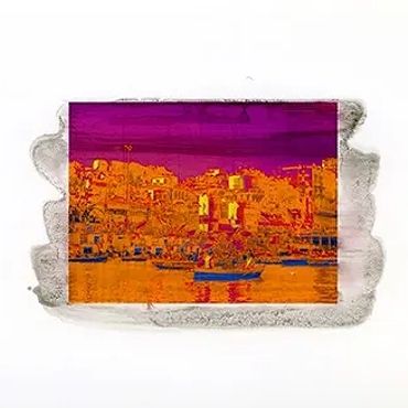 Colorful edited image of a riverside town with boats and buildings under a vibrant sky.