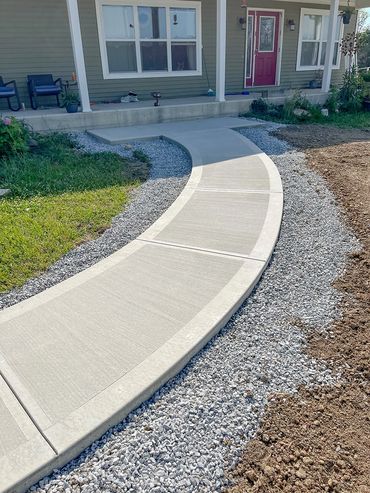 A curvy cement sidewalk.