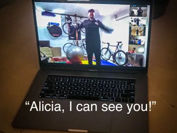 Person on video call with fitness equipment visible, captioned "Alicia, I can see you!"