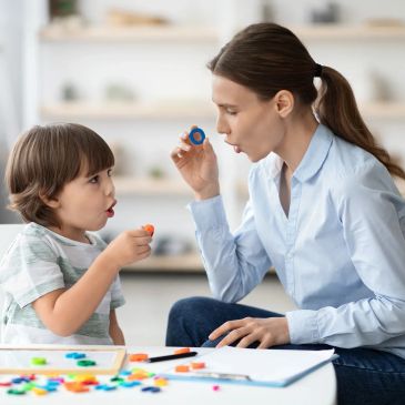 Mother and son blowing bubble rings together.