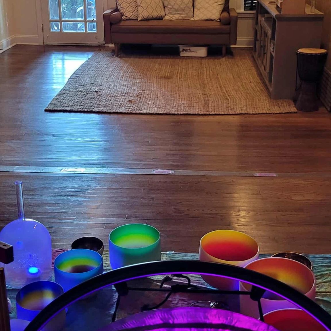 Singing bowls, goings, in a spa front room set up for a sound bath.