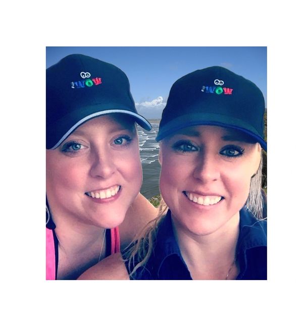 Female twins wearing baseball caps