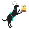 A black dog wearing a party hat and a teal harness, excitedly looking at a birthday cake with candles.