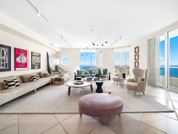 Bright modern living room with ocean view and minimalist decor.
