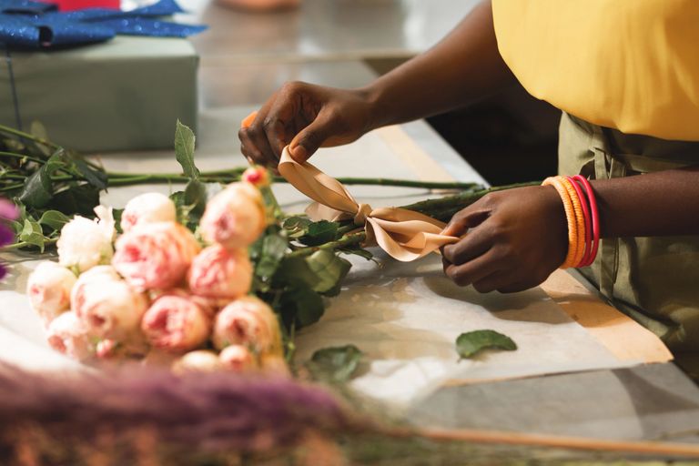 Business owner from BBB's Empower by GoDaddy business incubator working on a bouquet of flowers.