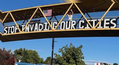 Sign: Stop Invading Our Cities