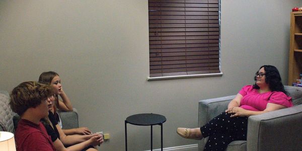 Four people having a conversation in a room.