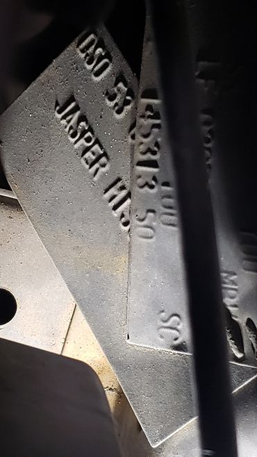 Close-up of metallic plates with embossed text.