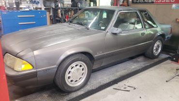 Vintage gray car in garage.