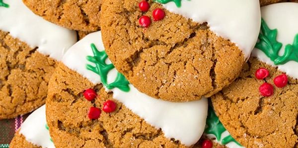 Festive ginger cookies decorated with white icing and red and green accents.