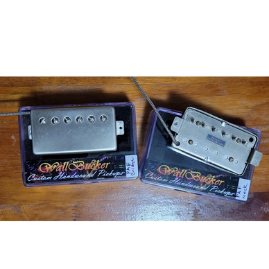 Two Wall Bucker custom guitar pickups on display boxes.