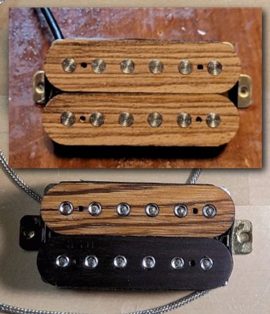 Two wooden and black electric guitar pickups with exposed pole pieces.