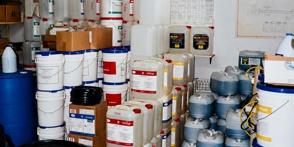 Storage room filled with various chemical containers and boxes.
