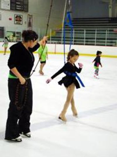 young figure skater using jump harness training system