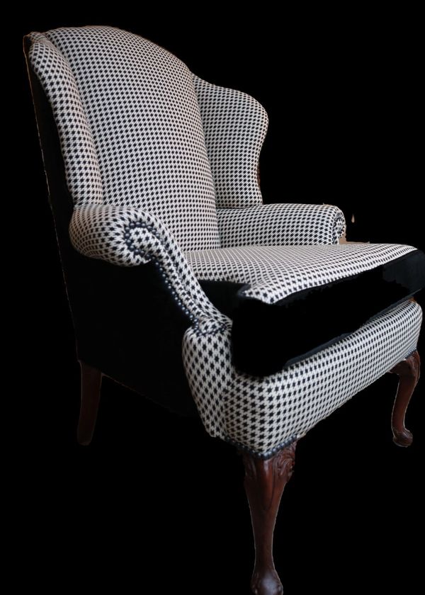 Classic upholstery: houndstooth and black velvet wingchair with black pearl decorative nails.