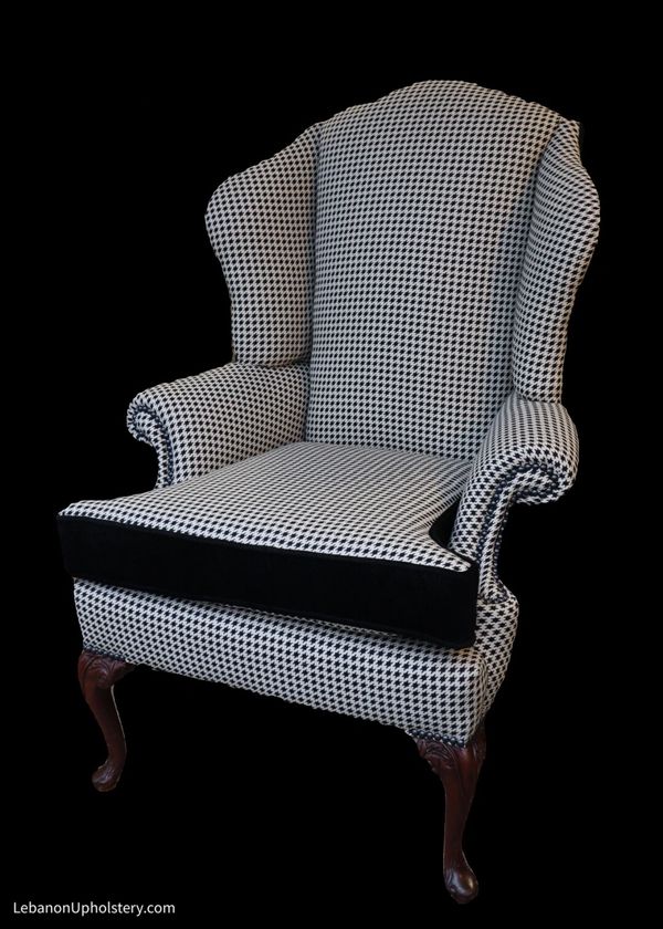 Classic upholstery: houndstooth and black velvet wingchair with black pearl decorative nails.
