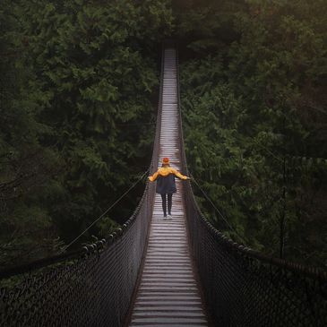 A man walking on a longest bridge in a jungle