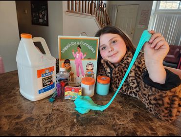 Making slime with the "Negativity is Contagious" book.
