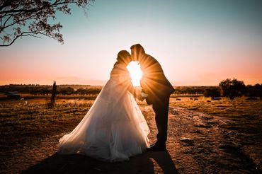 Wedding photography. Sunset photograph.A joyful wedding group photo in a scenic outdoor setting with smiling friends and family. Wedding Photography in Culcairn NSW. lea_bic Photography