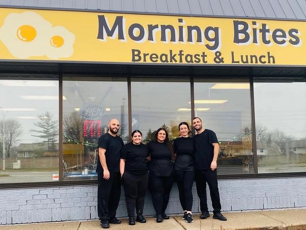 Five people standing in front of Morning Bites restaurant.