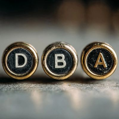 Typewriter keys with letters DBA or Fictitious Business Name Statement File and Publish PortfolioDBA