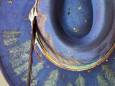 Blue felt hat with tree and star designs