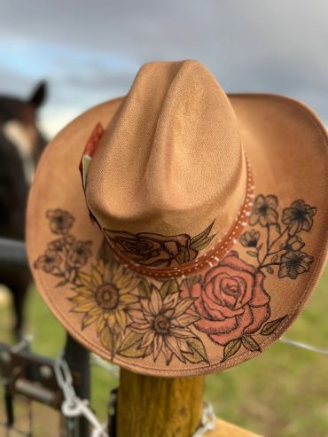 Tan cowboy hat with floral designs.