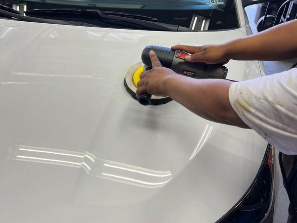 A white car being waxed