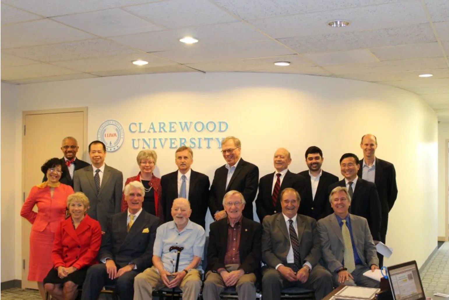 Group photo of 15 diverse professionals at Clarewood University.