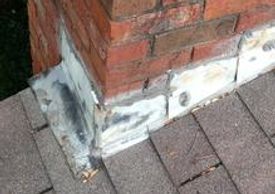old, damaged chimney metal flashing on a roof