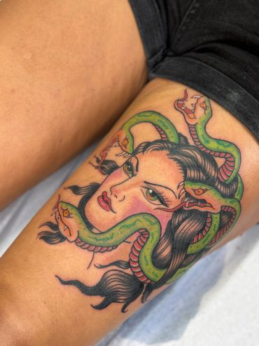 Tattoo of Medusa's head with snakes for hair.