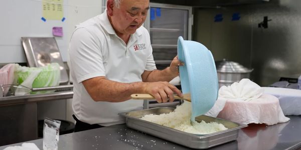 Man cooking rice in a kitchen.