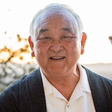 Smiling elderly man in casual wear outdoors.