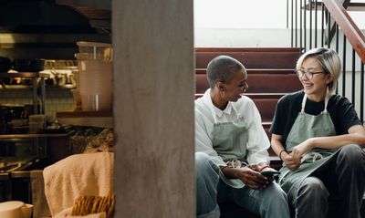 2 restaurant workers sitting and talking