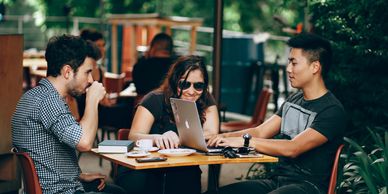 3 young people at a restaurant talking