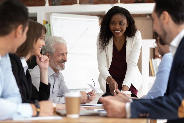 Business meeting  with people sitting at a table smiling