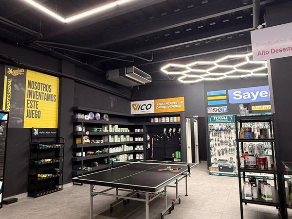 Indoor sports and retail space with a ping pong table and shelves of products.