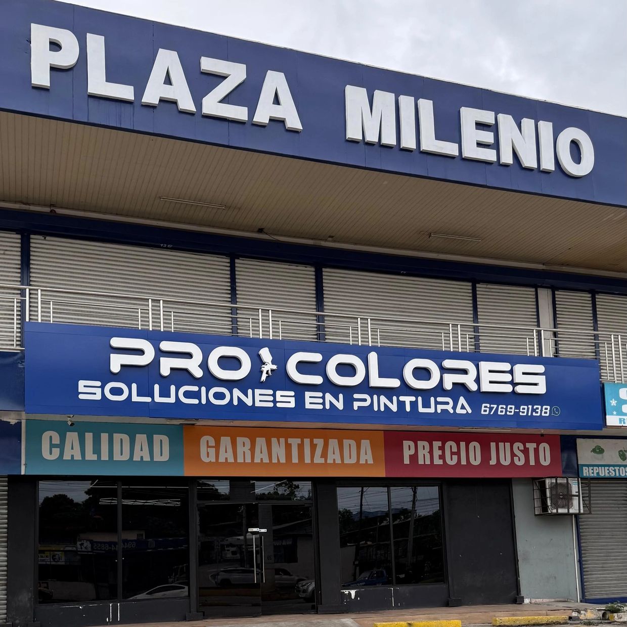 Facade of Plaza Milenio featuring Pro Colores paint solutions store with quality and fair price signs.