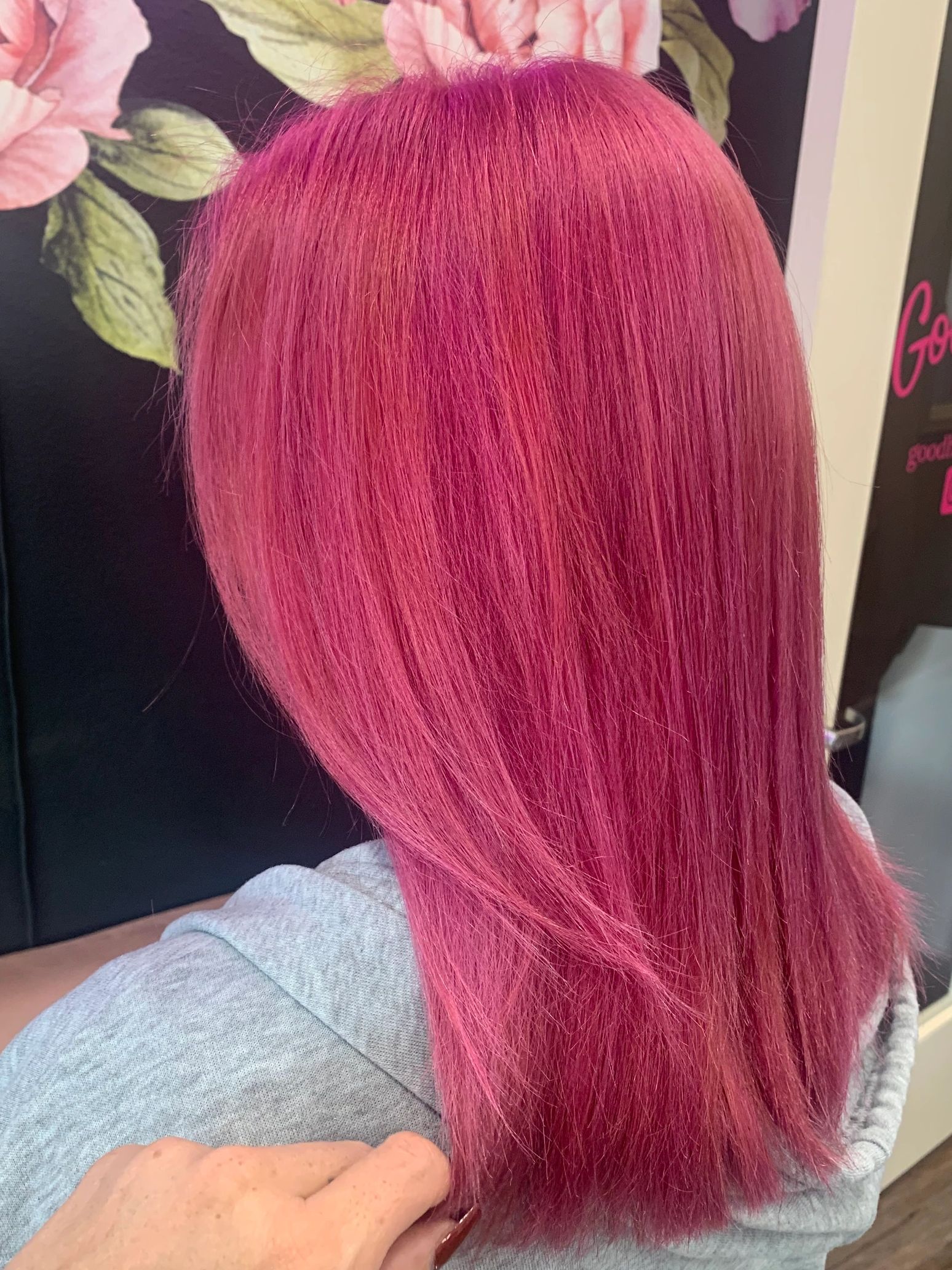Vibrant pink hair with straight texture.