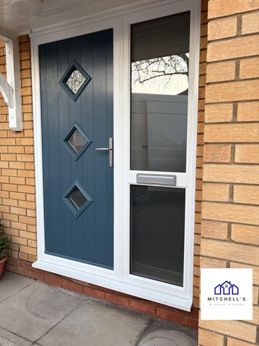 Modern blue front door with diamond-shaped windows and white frame.