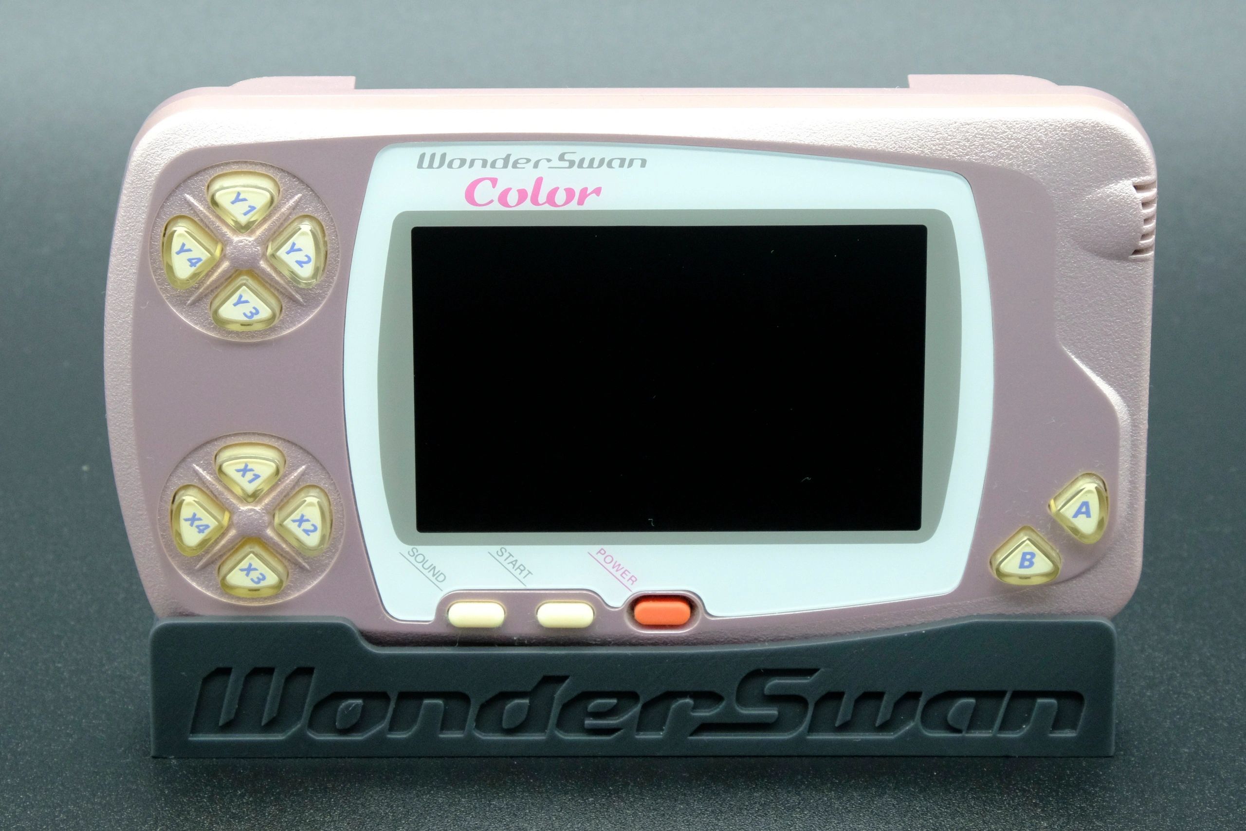 Image of a pearl pink Wonderswan Color.
