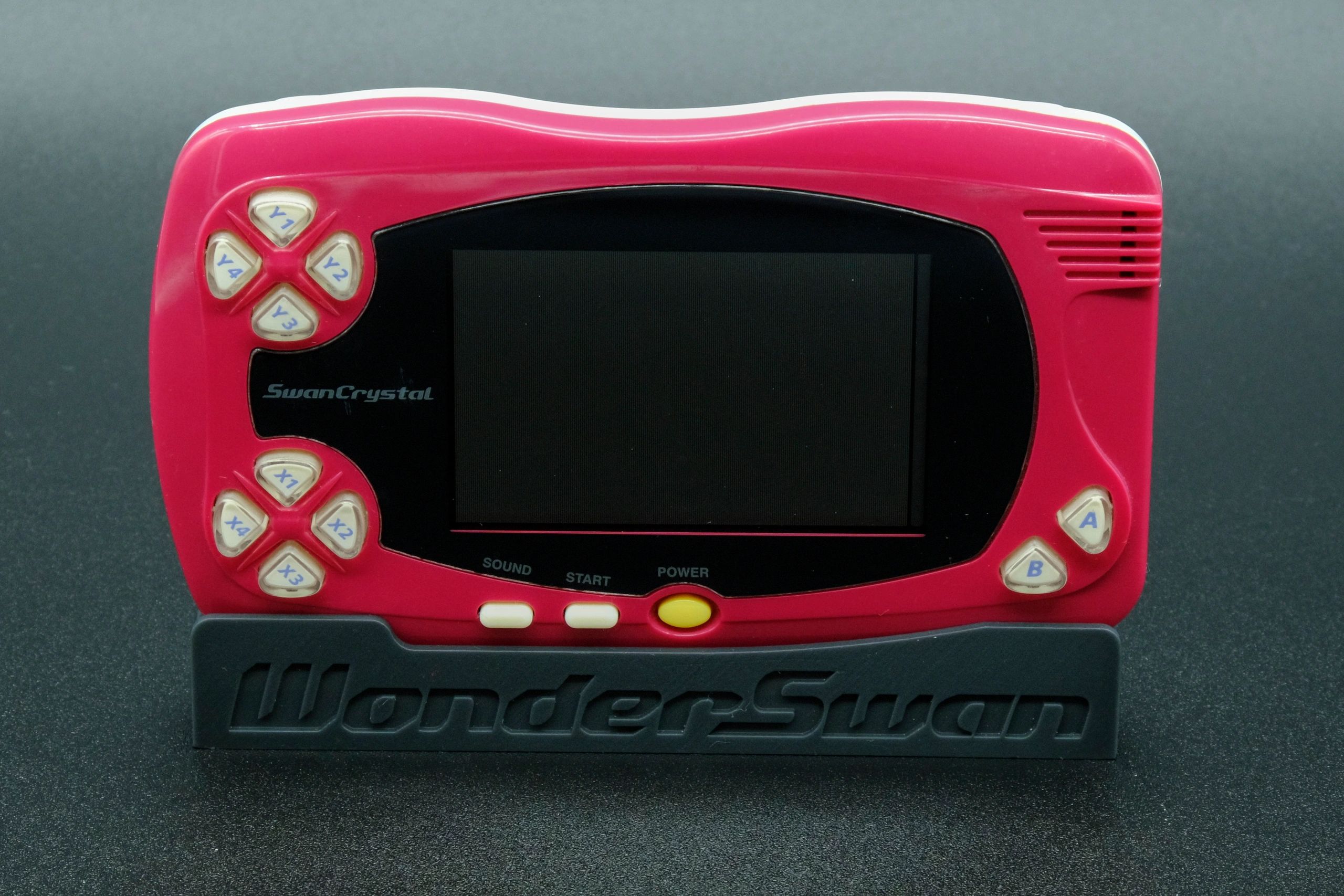 Image of a wine red Bandai Wonderswan SwanCrystal.