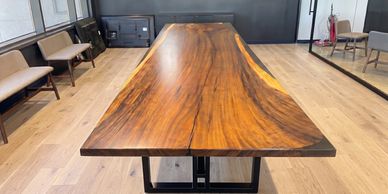 Wooden conference table with seating in a modern office.