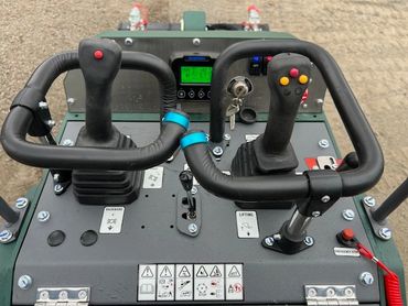 Control panel with dual joysticks and buttons for operating machinery.