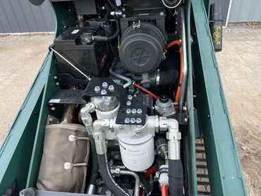 Close-up of a compact engine compartment with various components and wiring.