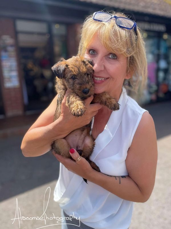 Donna Cox proprietor of Exmoor through the Lens holding a puppy