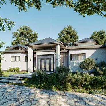 Modern house with clean lines and lush greenery under a clear blue sky.