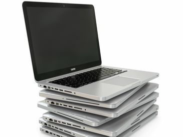 An image of a stack of computers that represent 65,000+ low-cost computers we have distributed.