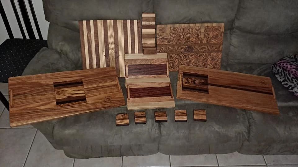 Handcrafted wooden serving trays and coasters with intricate patterns.